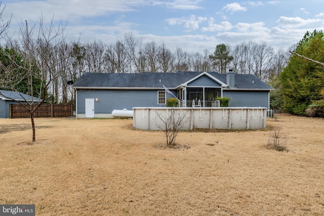 back of house featuring a sunroom