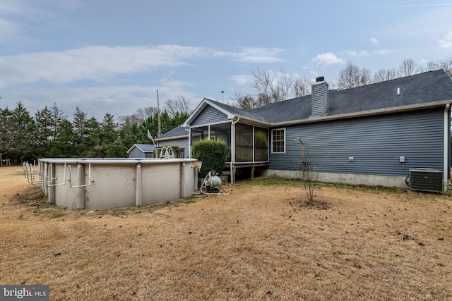 back of house with cooling unit and a sunroom