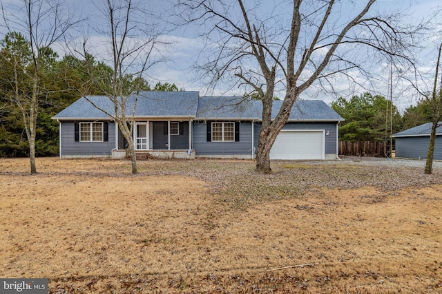 view of front facade featuring a porch and a garage