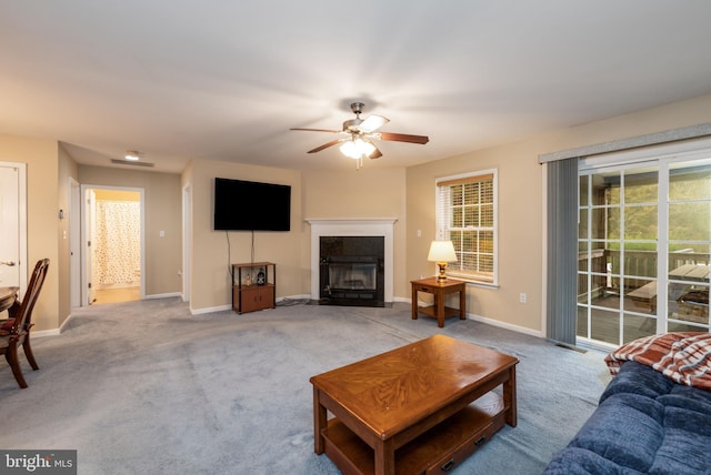 living room featuring light colored carpet and ceiling fan