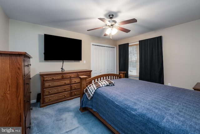 carpeted bedroom featuring ceiling fan and a closet