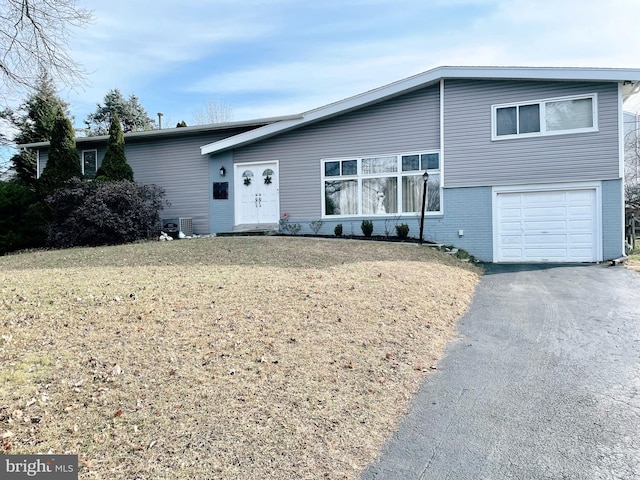 view of front of property featuring a front yard and a garage