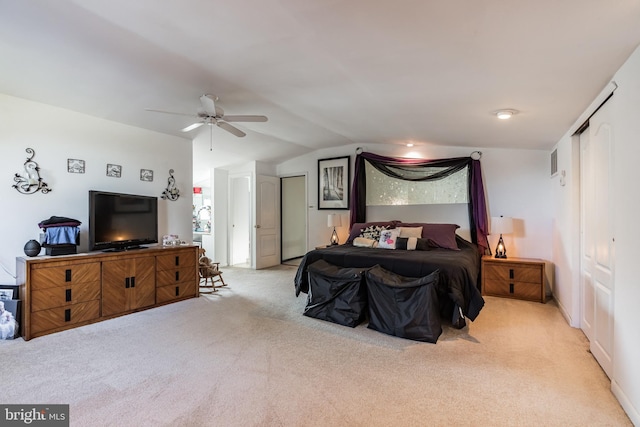 bedroom with ceiling fan, lofted ceiling, and light carpet