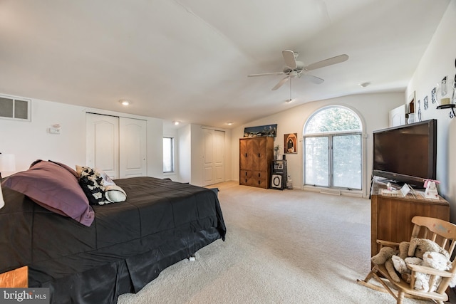 bedroom featuring ceiling fan, light colored carpet, and vaulted ceiling