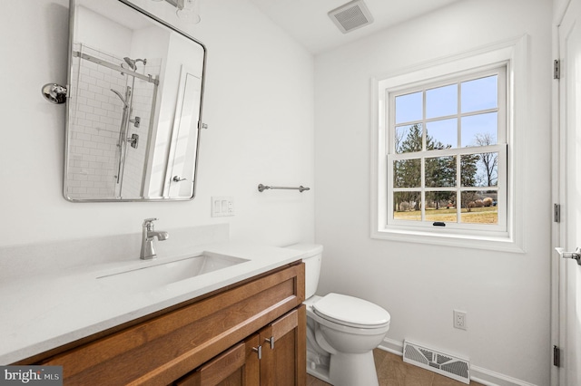 bathroom with vanity, tile patterned floors, a shower, and toilet