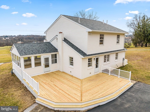 rear view of property featuring a deck