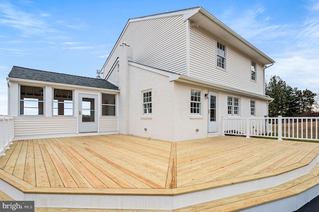 back of house featuring a wooden deck