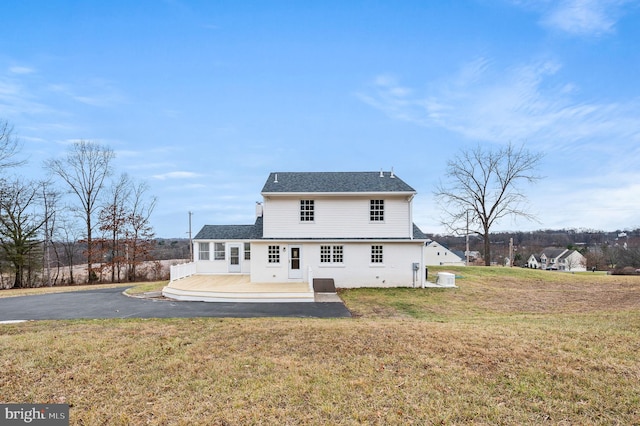 back of house featuring cooling unit, a yard, and a deck