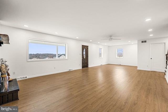 living room featuring light hardwood / wood-style flooring and ceiling fan