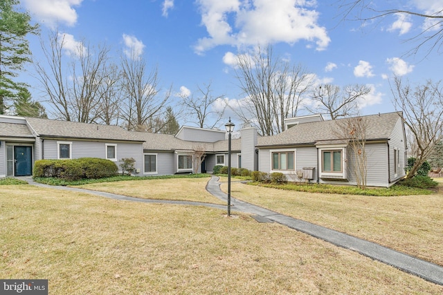 ranch-style home with a front lawn