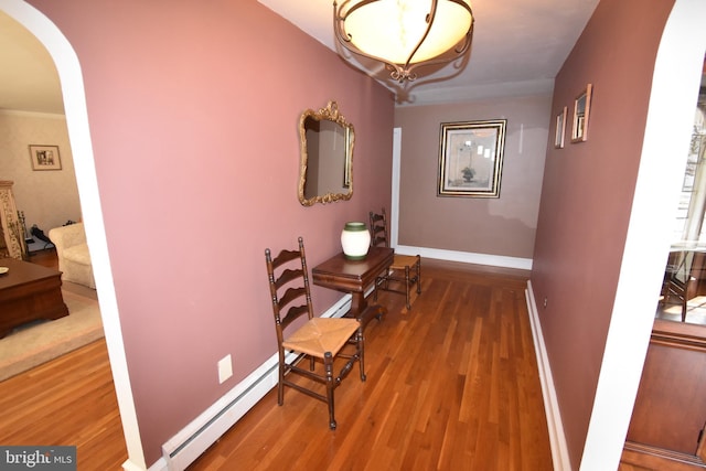 corridor featuring a baseboard radiator and wood-type flooring