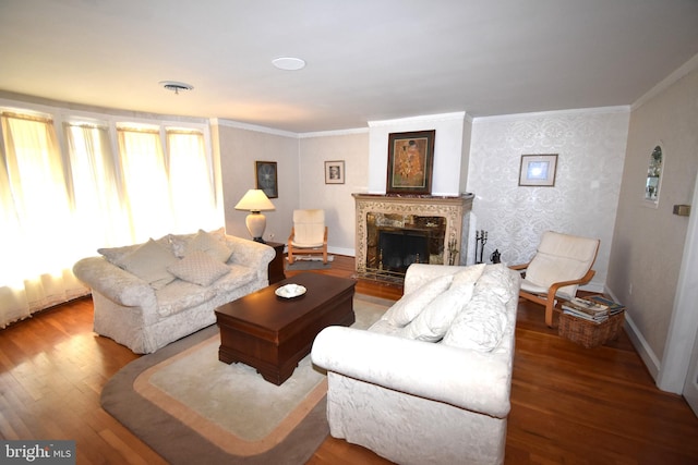 living room featuring crown molding, hardwood / wood-style floors, and a fireplace