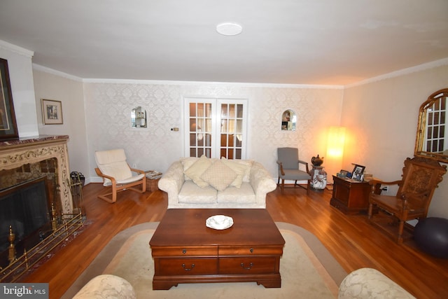 living room featuring a premium fireplace, ornamental molding, and hardwood / wood-style floors