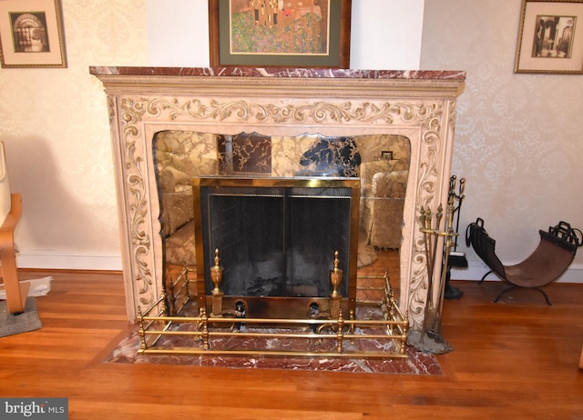 details with wood-type flooring and a premium fireplace