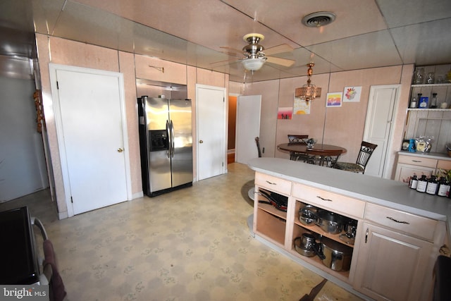 kitchen with a drop ceiling, stainless steel fridge, and ceiling fan