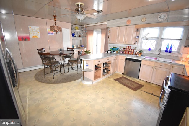 kitchen featuring sink, a baseboard radiator, kitchen peninsula, ceiling fan, and stainless steel appliances