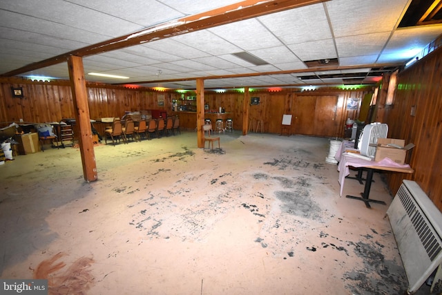 basement with heating unit and wooden walls