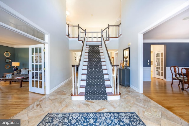 staircase featuring tile patterned floors, french doors, and ornamental molding