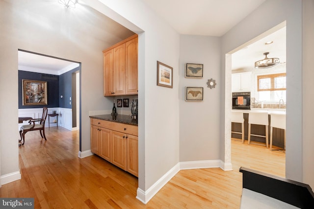 corridor featuring light hardwood / wood-style floors and ornamental molding