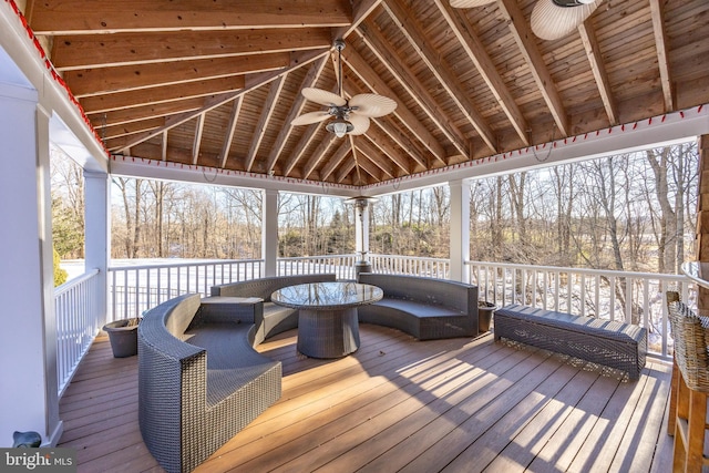 wooden terrace featuring ceiling fan and an outdoor living space