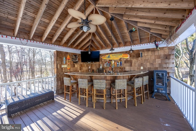 wooden terrace featuring an outdoor bar and ceiling fan