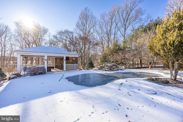 yard layered in snow with covered porch