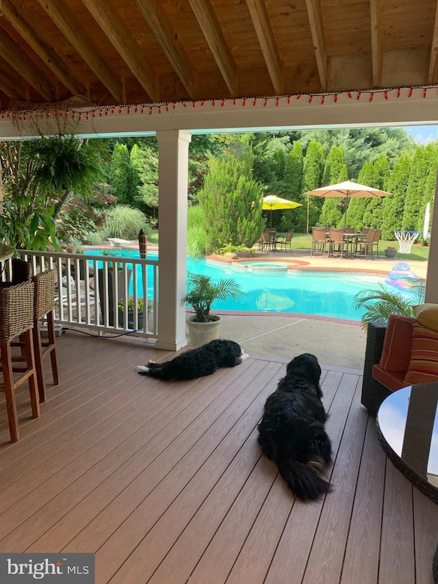 view of swimming pool with a wooden deck