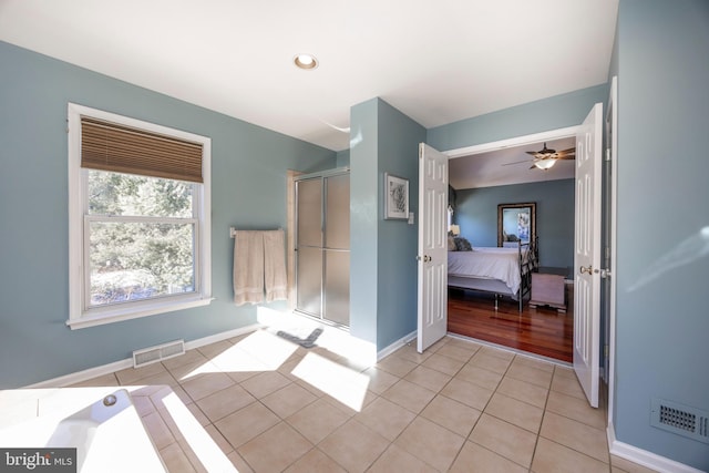 bathroom with tile patterned floors and ceiling fan