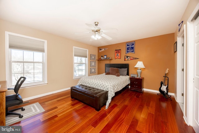 bedroom with dark hardwood / wood-style flooring and ceiling fan