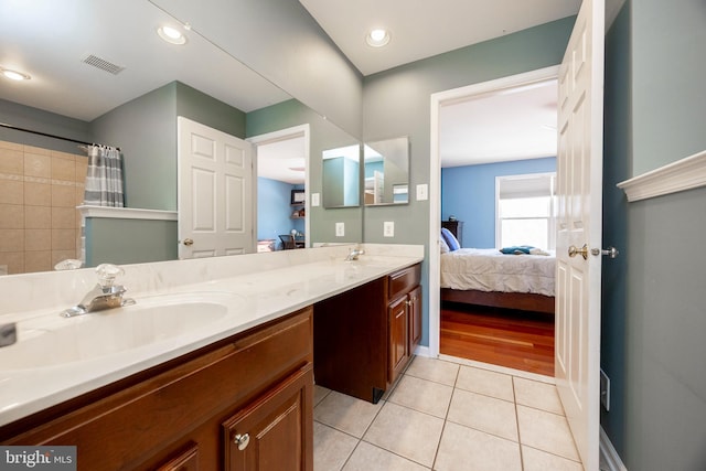 bathroom featuring vanity, tile patterned floors, and walk in shower