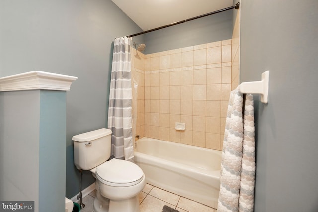 bathroom featuring tile patterned flooring, shower / tub combo with curtain, and toilet