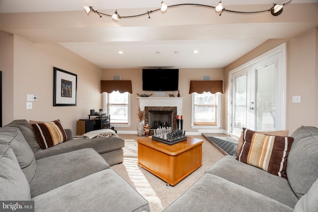 living room with light colored carpet and a premium fireplace