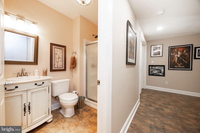 bathroom with a shower with door, vanity, and toilet