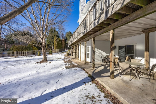 yard covered in snow featuring a balcony