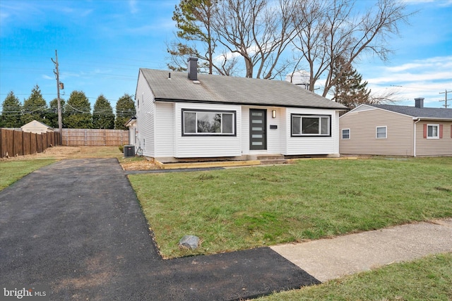 view of front of home with a front yard and cooling unit