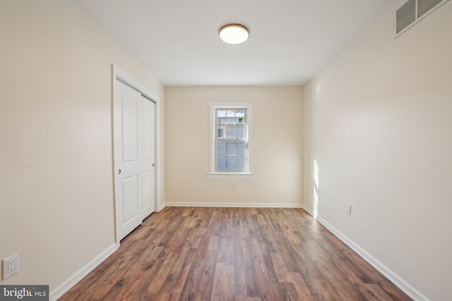 empty room featuring dark hardwood / wood-style flooring