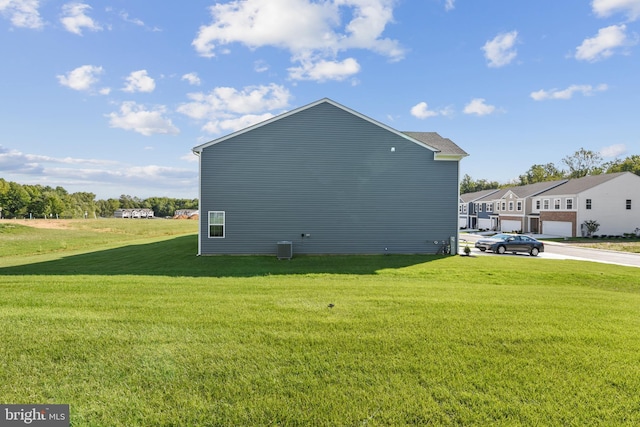 view of property exterior with a lawn