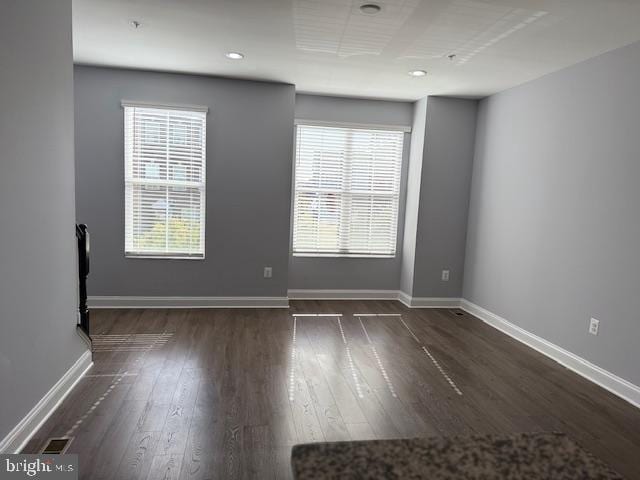 unfurnished room featuring dark hardwood / wood-style flooring