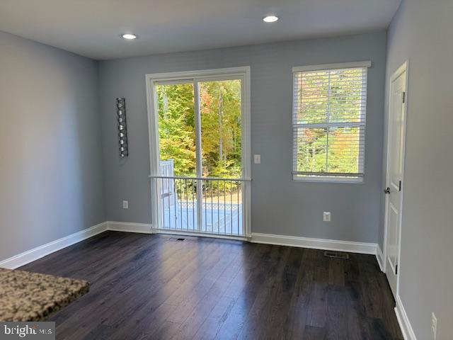 unfurnished room featuring dark wood-type flooring