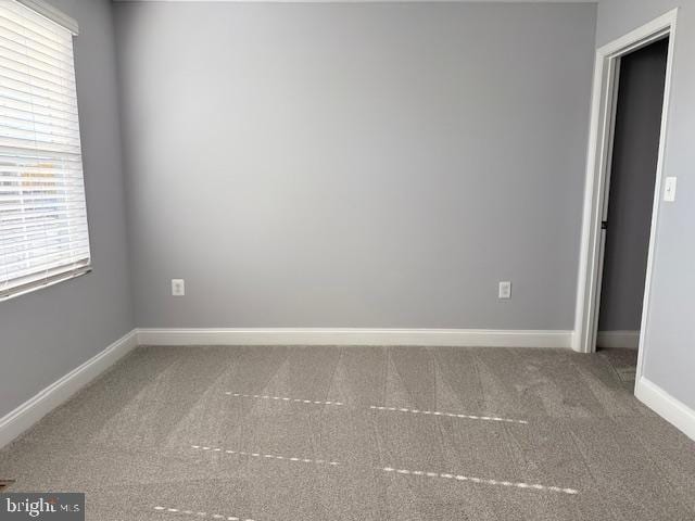 carpeted spare room featuring plenty of natural light