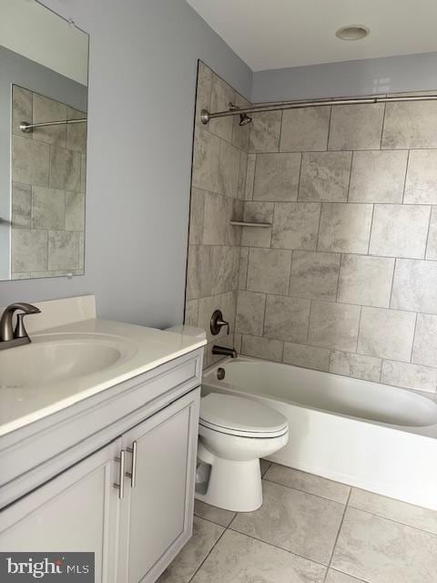 full bathroom with tile patterned floors, vanity, toilet, and tiled shower / bath