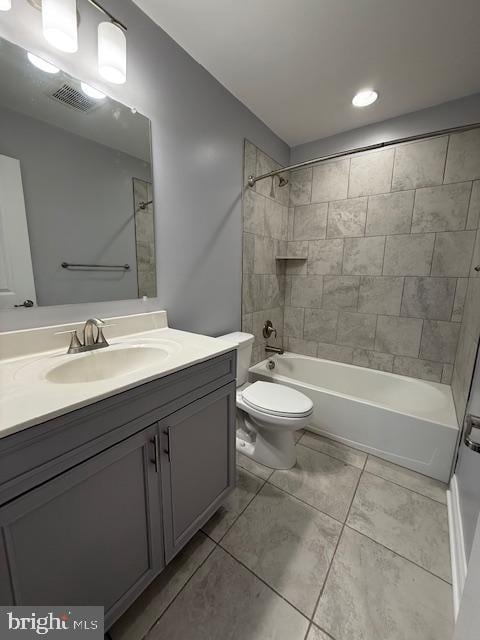 full bathroom featuring vanity, toilet, and tiled shower / bath