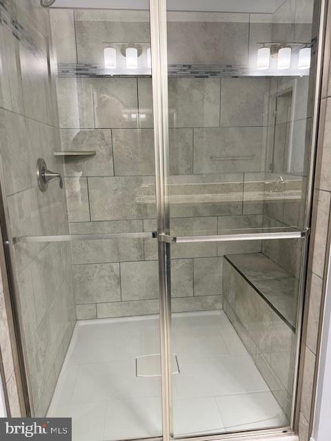 bathroom featuring a shower with door