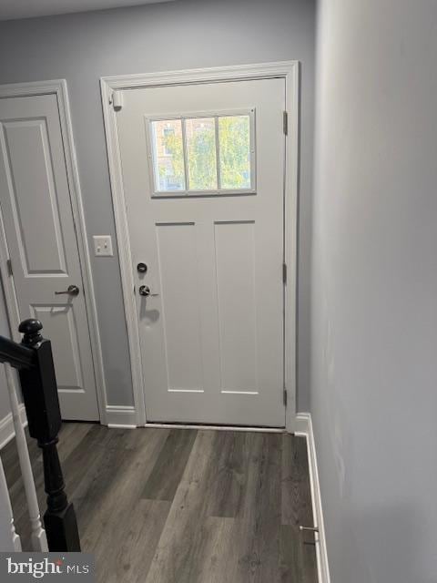 doorway to outside featuring dark wood-type flooring