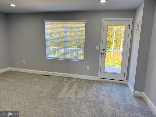 doorway featuring carpet floors