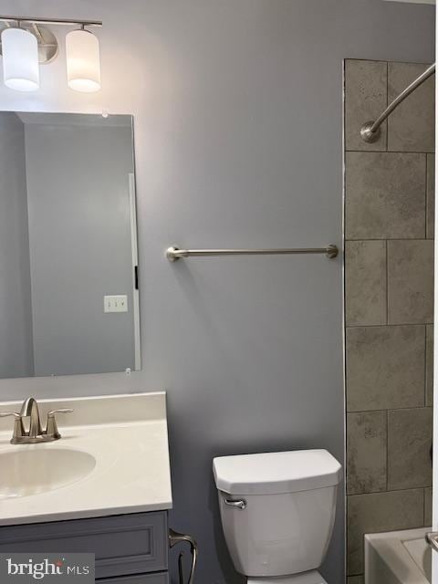 full bathroom with vanity, toilet, and tiled shower / bath combo