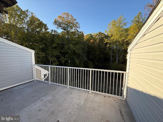 view of patio featuring a balcony