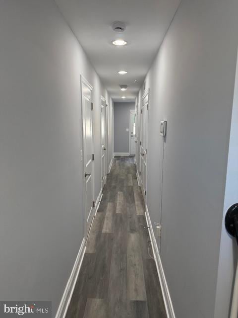 corridor with dark hardwood / wood-style floors