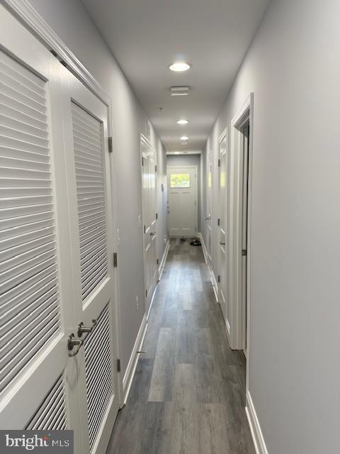 hallway with dark hardwood / wood-style flooring