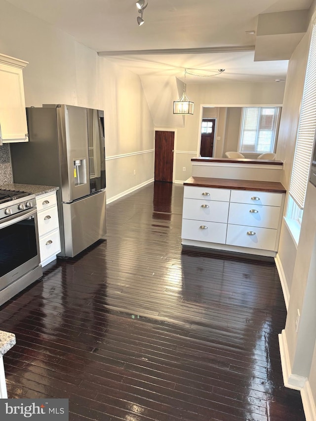 kitchen with white cabinetry, backsplash, dark hardwood / wood-style flooring, stainless steel appliances, and an inviting chandelier